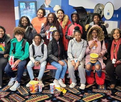 Group picture of students from Franklin Middle School before going to see Wakanda Forever, November 18, 2022 at Collins Road Theatre.