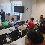 The Academy for Scholastic and Personal Success 2023 Summer Session. Students listening to Eric M. Thompson, ASPS Assistant Director