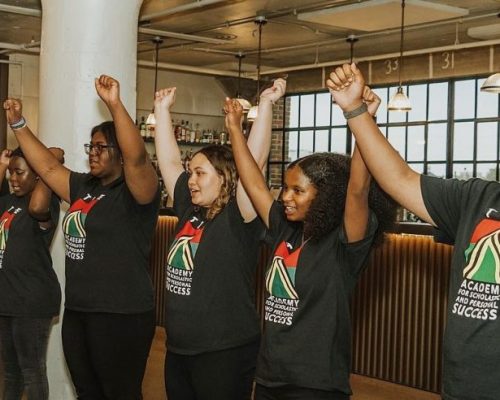 ASPS Students raising their arms during their presentation at the 2023 ASPS Gala